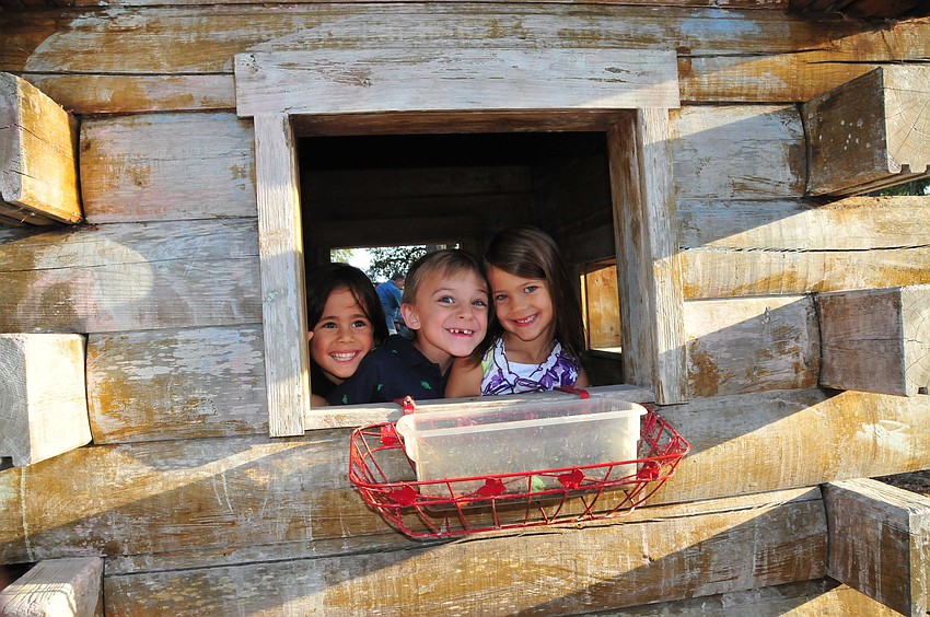 Charlie Rasool, Jackson Fink, and Wednesday Peterson enjoy friendship and laughter in the Forty Carrots playhouse after their Pre-K graduation.