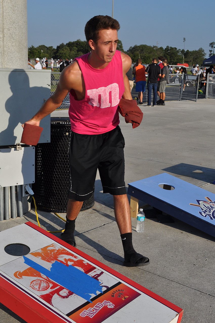 Colin Thomsen plays a game of corn hole.