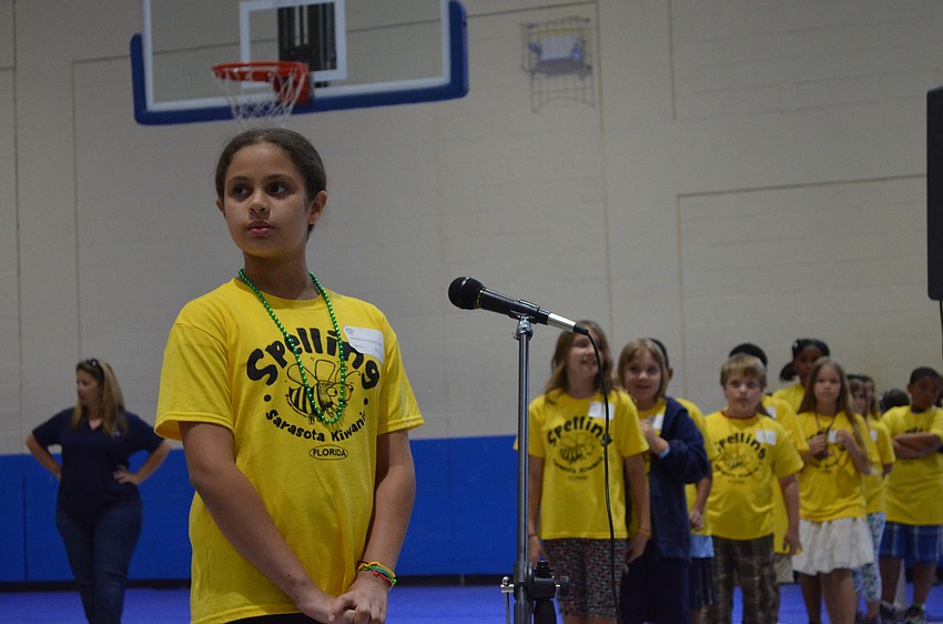Fourth grader Genesis Riquelme listens to the word Larry Bowman reads.