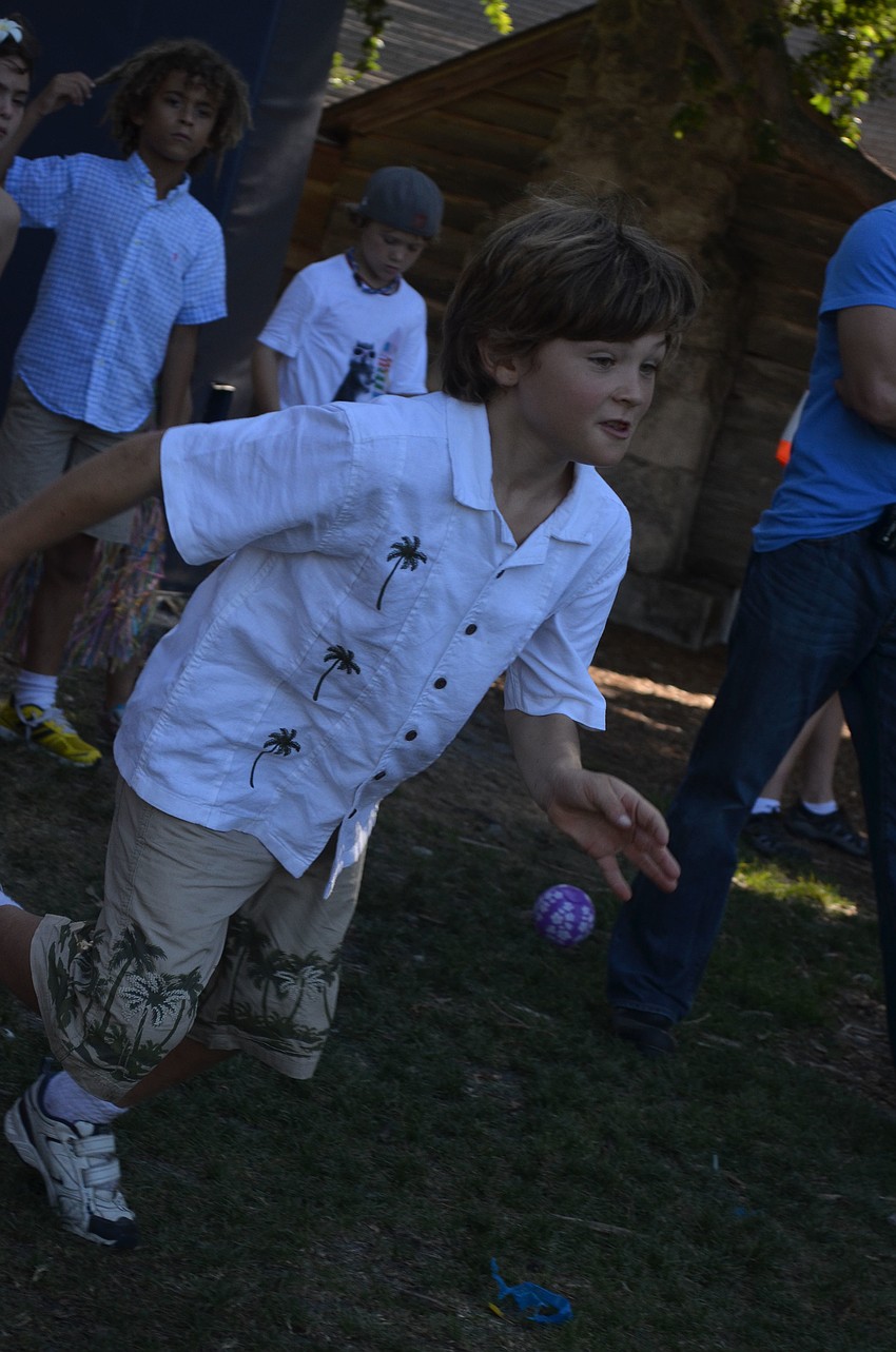 Tyler B. sprints to first base during a game of kickball.