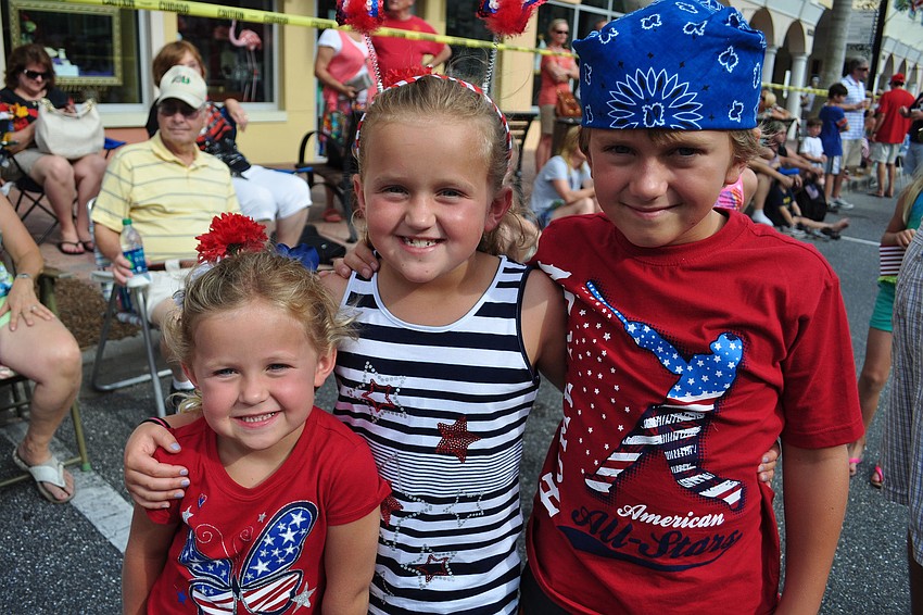 Izzy, Sarah and Andy Montague wait in line for a balloon animal.