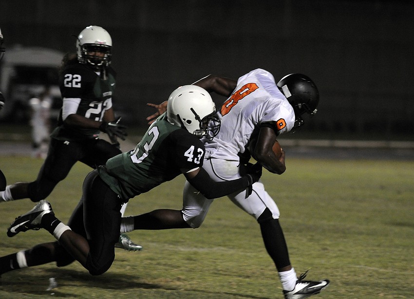Lakewood Ranch linebacker Allen Remedor wraps up a Naples Lely running back to eliminate a big gain.