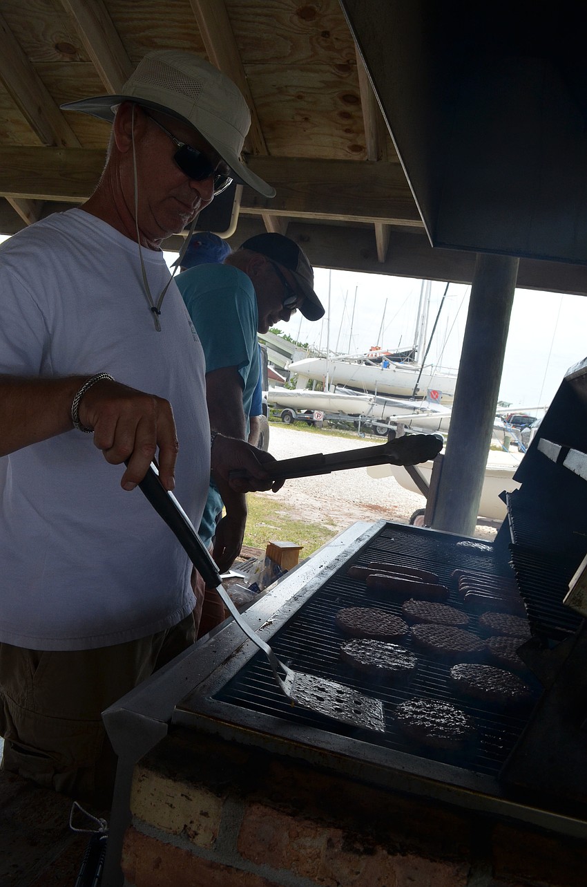 Don Herndon grills hotdogs and burgers at the BBQ after the race.