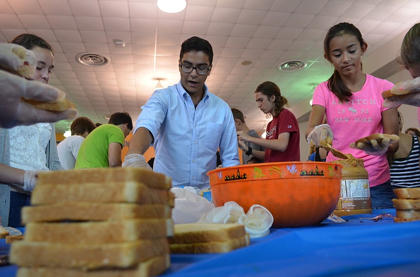 Senior Brian Hajal was the table captain and instructed students like sixth grader Sena Szczepaniuk how to spread the soy butter and jelly.