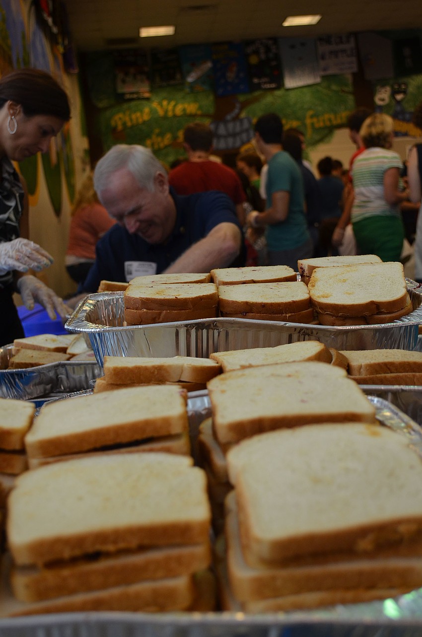 Community Youth Development Program Director Yolanda Mancha and Vice Chairman of Sarasota Military Academy Herb Jones count sandwiches and make sure they qualify.