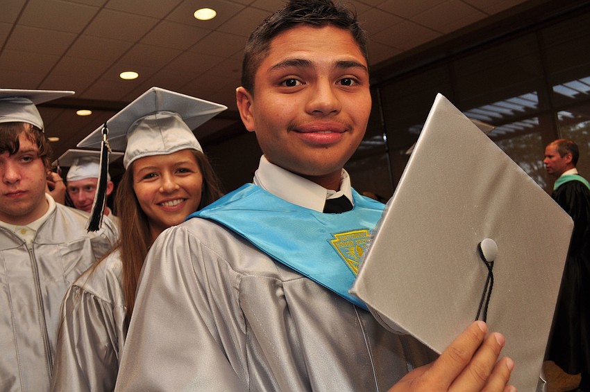 Juan Garcia adjusts his cap before the ceremony.