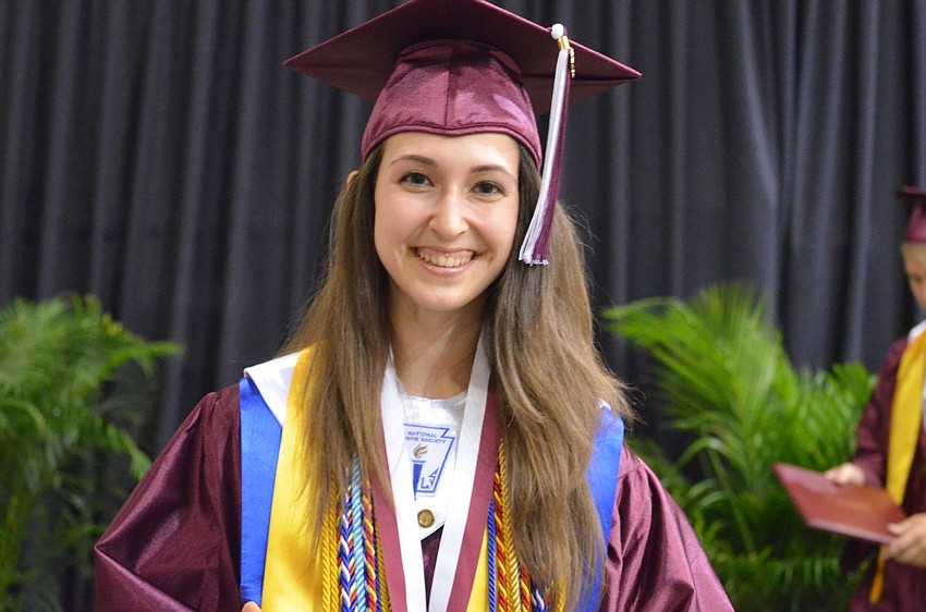 International Baccalaureate senior Cristina Chiodi accepts her diploma. Chiodi helped organize the Emilia:Run for Relief 5K and 1-mile earlier in the year, to help earthquake victims of the Emiliaâ€“Romagna region of Italy.