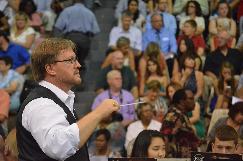 Associate Director of Band Norm Vaughn conducts the orchestra of students.