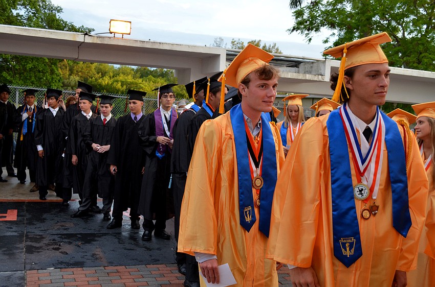 Graduates enter the Sarasota High School football field.