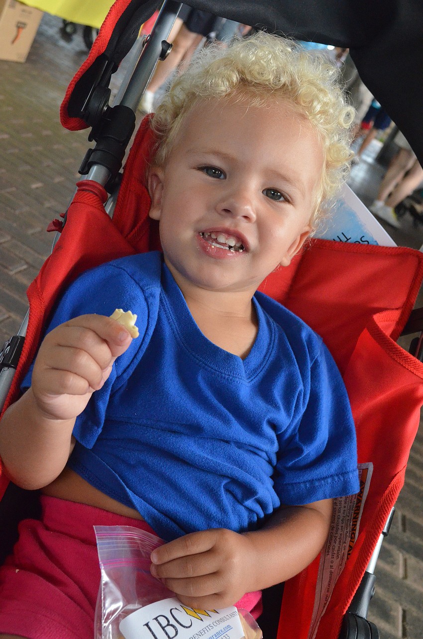 Buck Rowell, 2, munched on snacks on his way out of World Ocean Day at Mote.