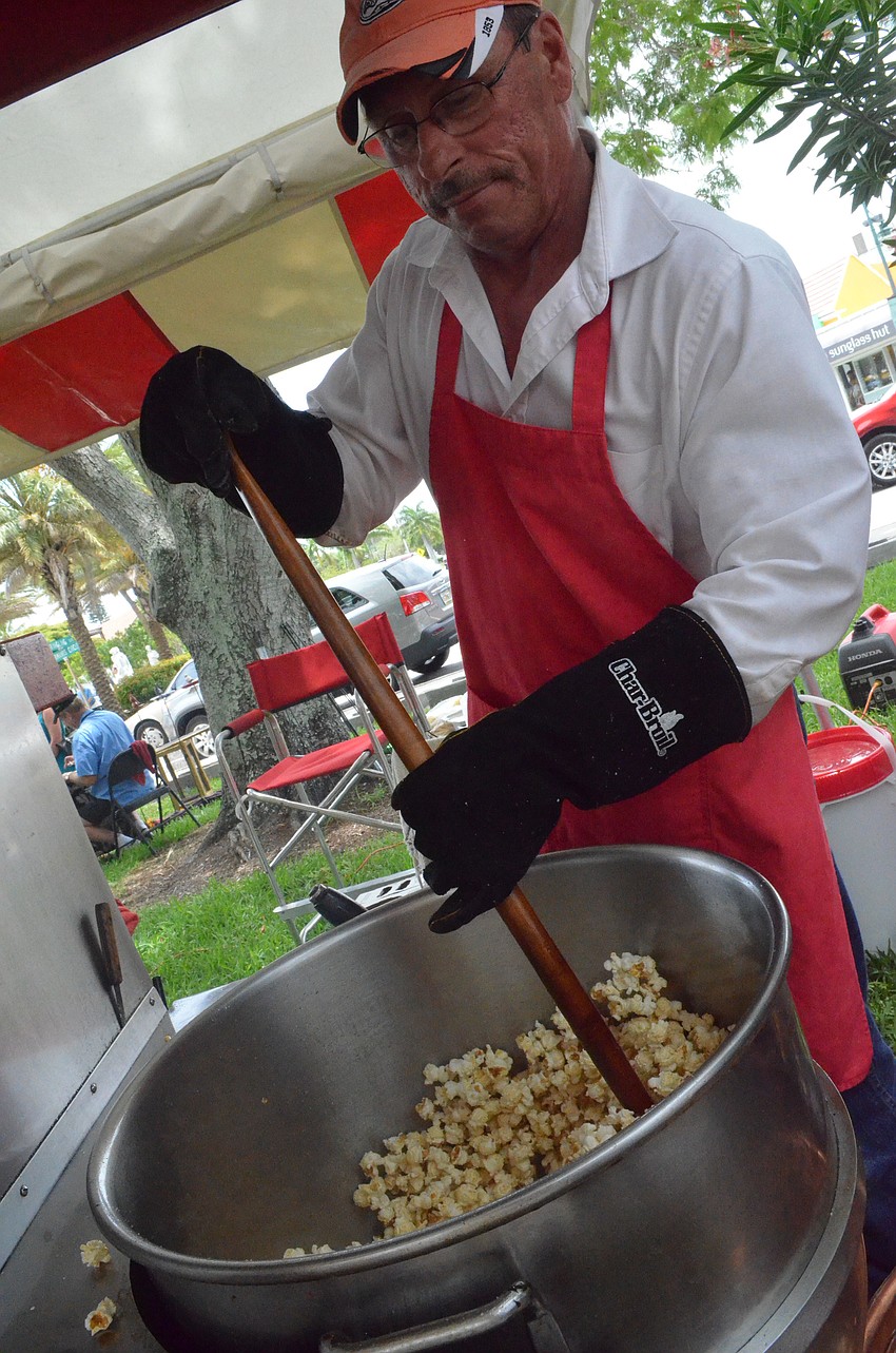 Rick Drollette makes sweet smelling popcorn at the Kettle Corn stand.