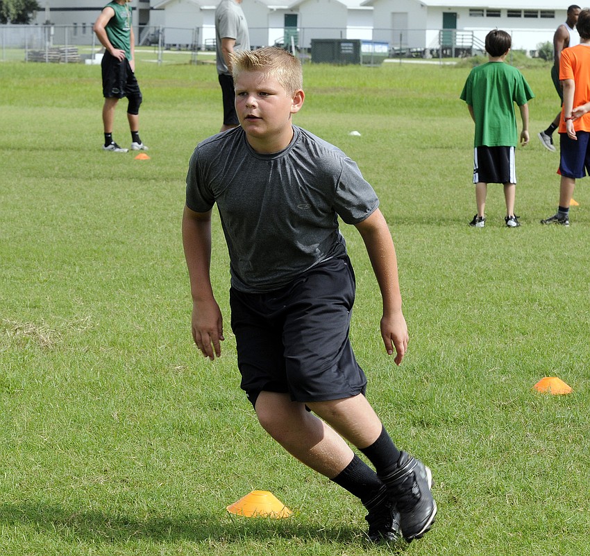 Manatee Mustangs middle linebacker Luke Reeves work on his footwork during an agility drill.