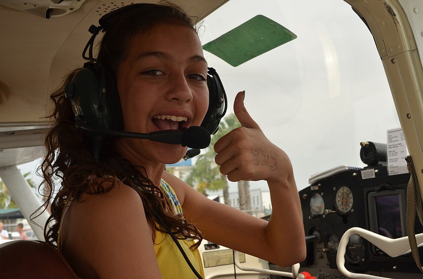 Denise Cribbs, 12, gives a thumbs up before taking off.