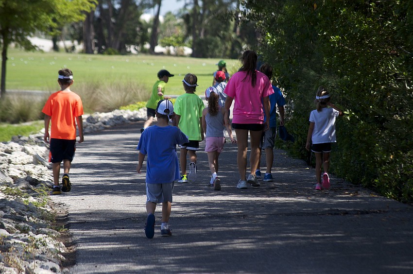 The Summer Sport Camp campers walk to the driving range.