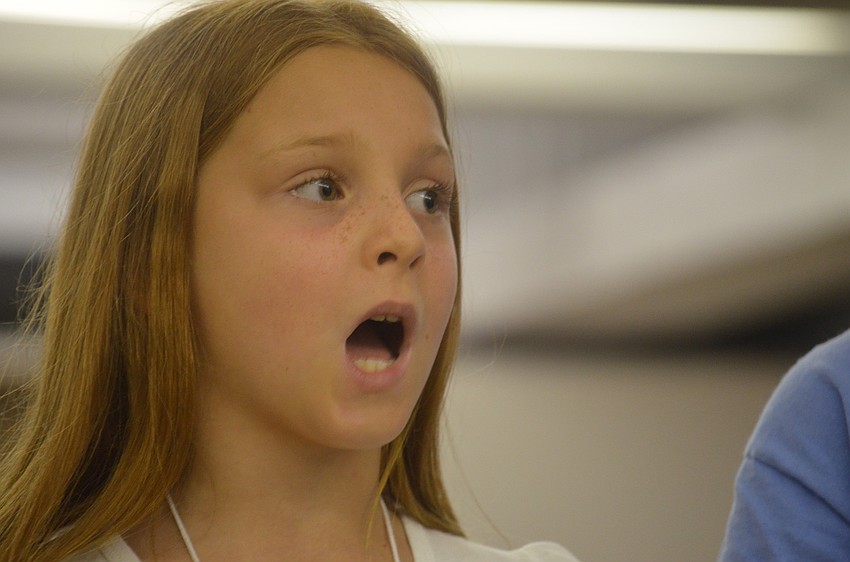 Madeline Boehm sings along with her campmates.