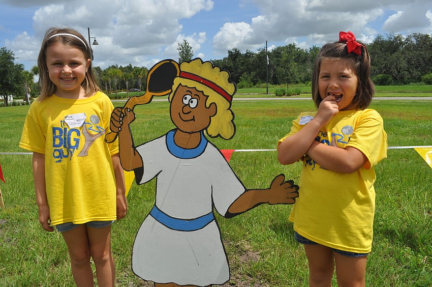 Olivia Shepard and Hannah Harper pose with a cartoon cutout of David.