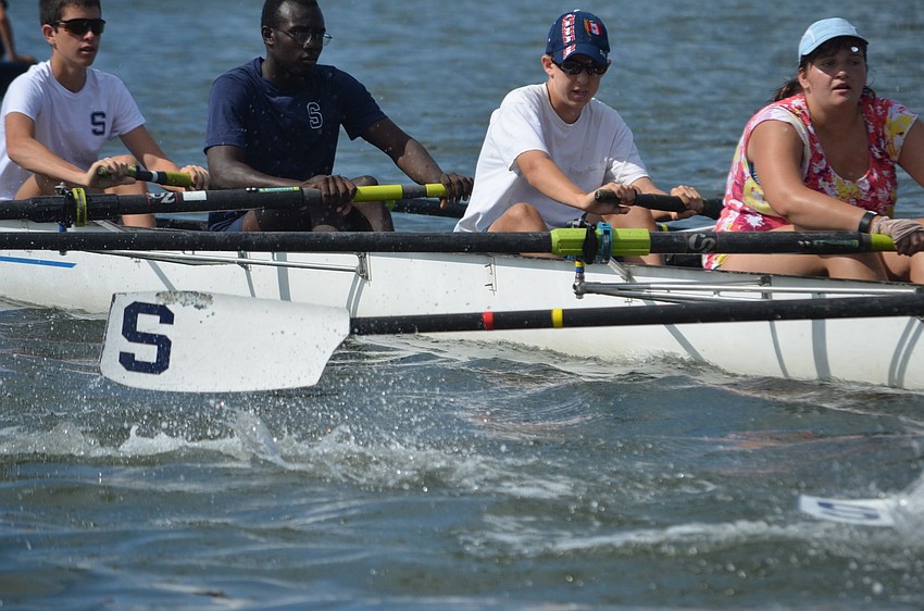 Carly Adelman, Ben Carry, Tromaine James and Max Yturraspe race against other rowers.