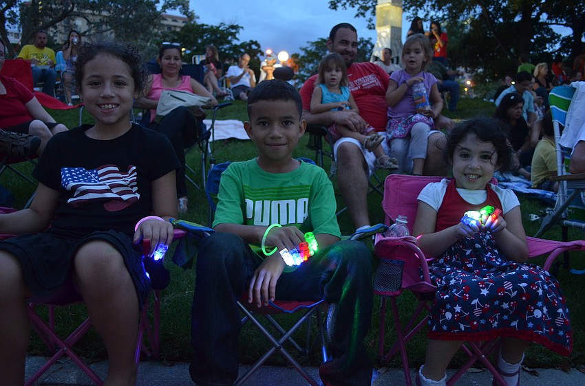 Melanie Gonzalez, 9, plays with glow bracelets with her cousin Angel Gabriel, 9, and her little sister Leilani.