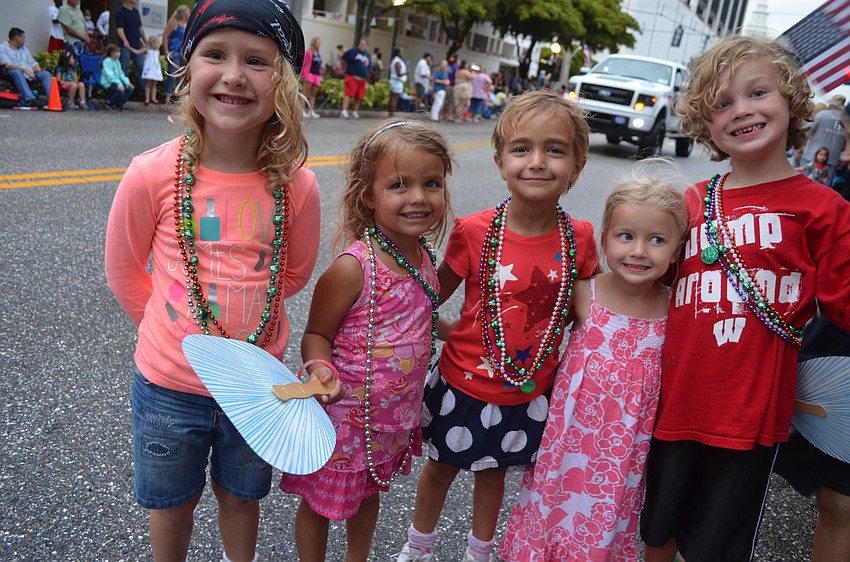 Jaidyn McAlister, 5, Alex Misantone, 3, her sister Stella, 5, Alana Biller, 3, and Austin, 6, all watch the parade and play together.