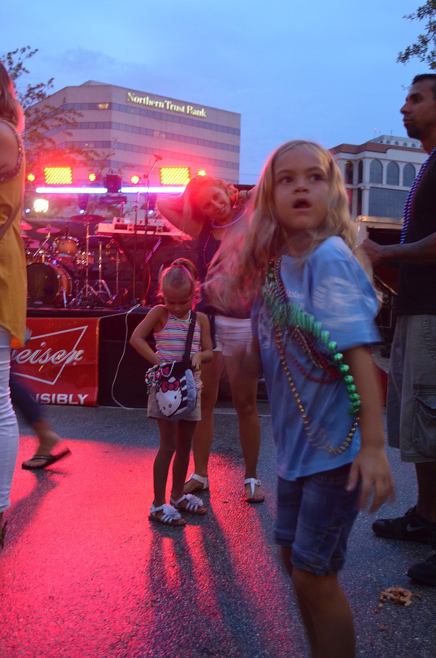 Kara Crawford, 7, dances to pop music at the block party.