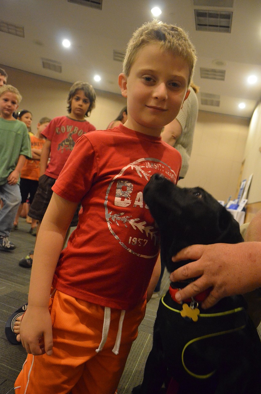 Ayden Shapoiro, 7, pets 17-week old Kaleb.