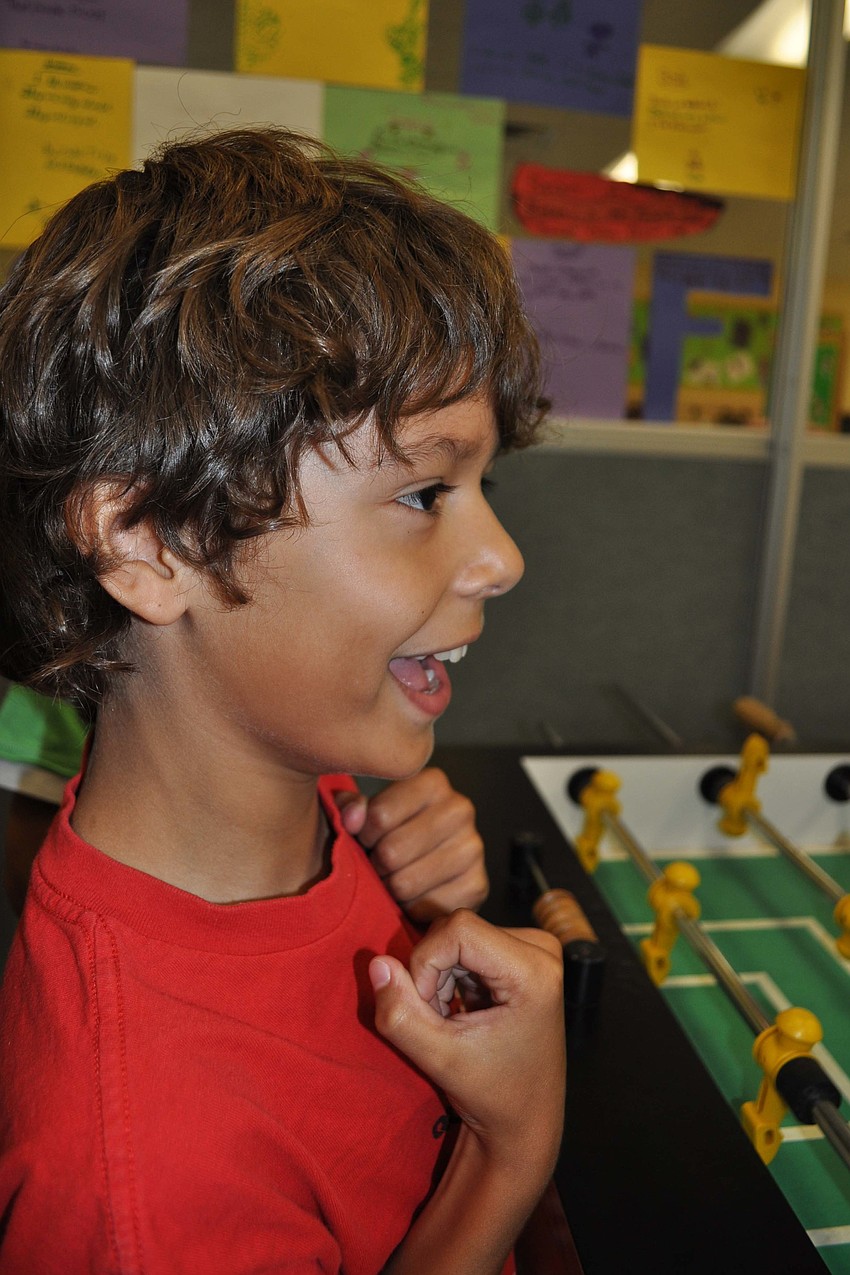 Kaleb Rice, 8, celebrates as his team scores a point.