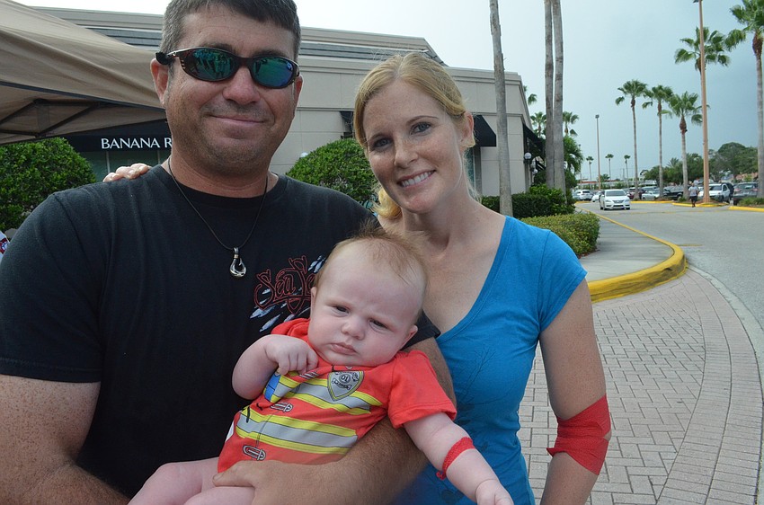 Sarasota County Firefighters Mike Schaffer and Holly Vickers hold their 2-month old daughter Lexi Schaffer.