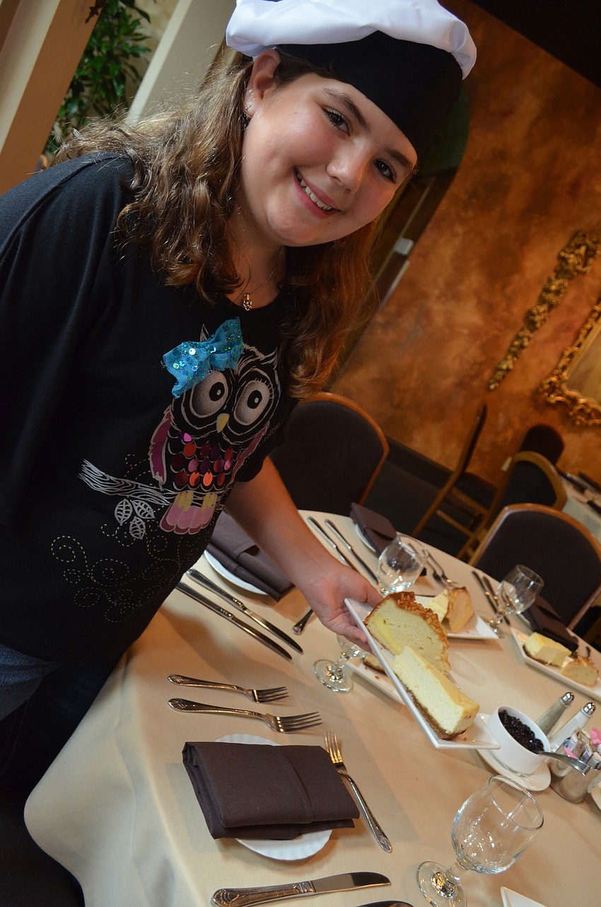 Valerie Wojcik, 10, sets the table and brings out the desert.