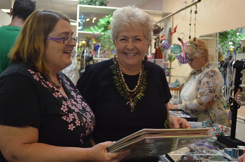 Karen Johnson presents Marty Montague with a scrapbook reflecting upon the past 20 years.