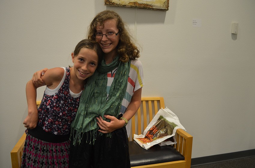 Sisters Cameron and Erin Boudreau show off their new clothing they swapped at the clothing swap.