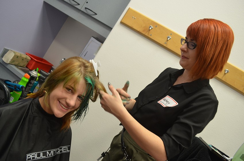 Whitney Liller volunteers her time to do model Morgan Gerhardtâ€™s hair. She dyes her tips green for the fashion show.