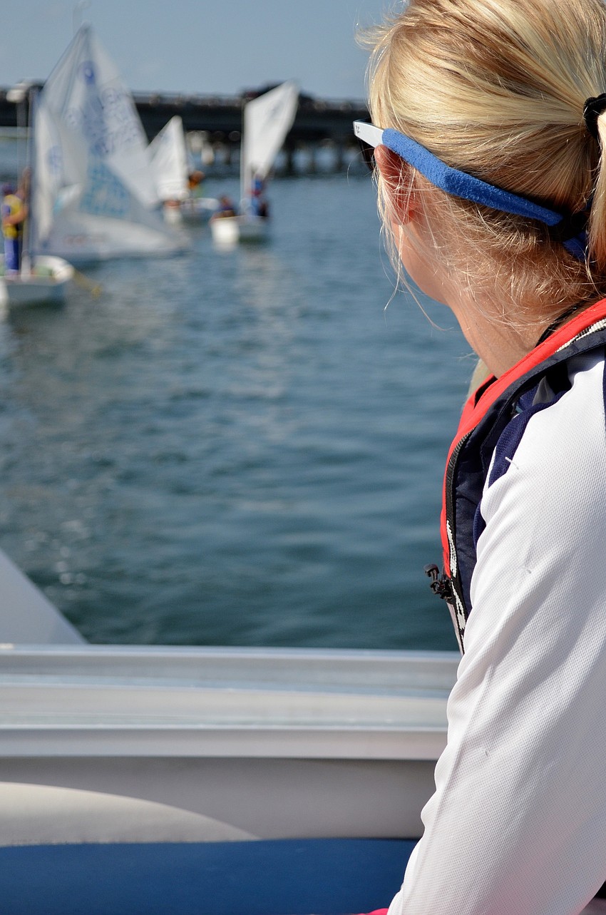 Camp volunteer Hallie Schiffman watches as the campers put up their sprit poles.
