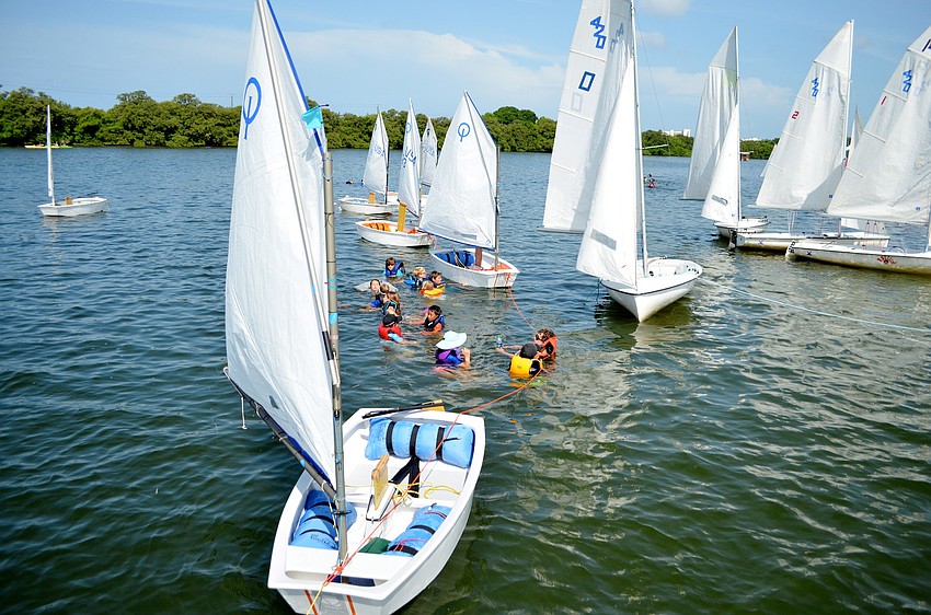 The campers take a break from sailing and go for a swim.