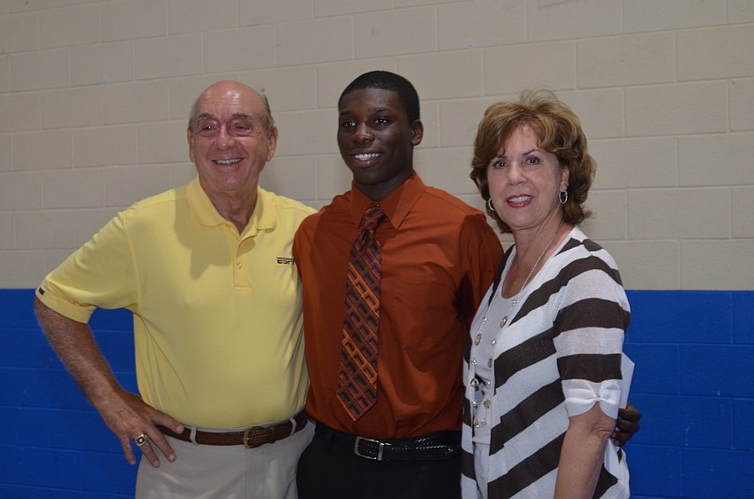 Dick and Lorraine Vitale present 18-year-old North Port High School graduate Caio Gilot with a $1,000 scholarship. Gilot plans to study criminal justice at State College of Florida.