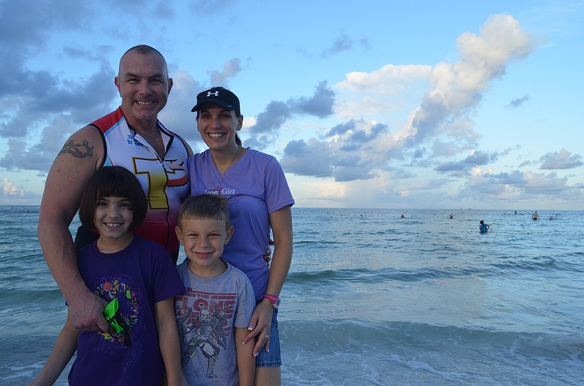 Doug Whiteâ€™s wife Michele and children Peyton, 8, and Houston, 6, support him as he competes in the Sprint Triathlon.