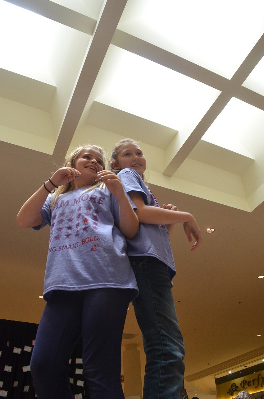 Alyssa Currier and Bianca Butram confidently walk down the runway.