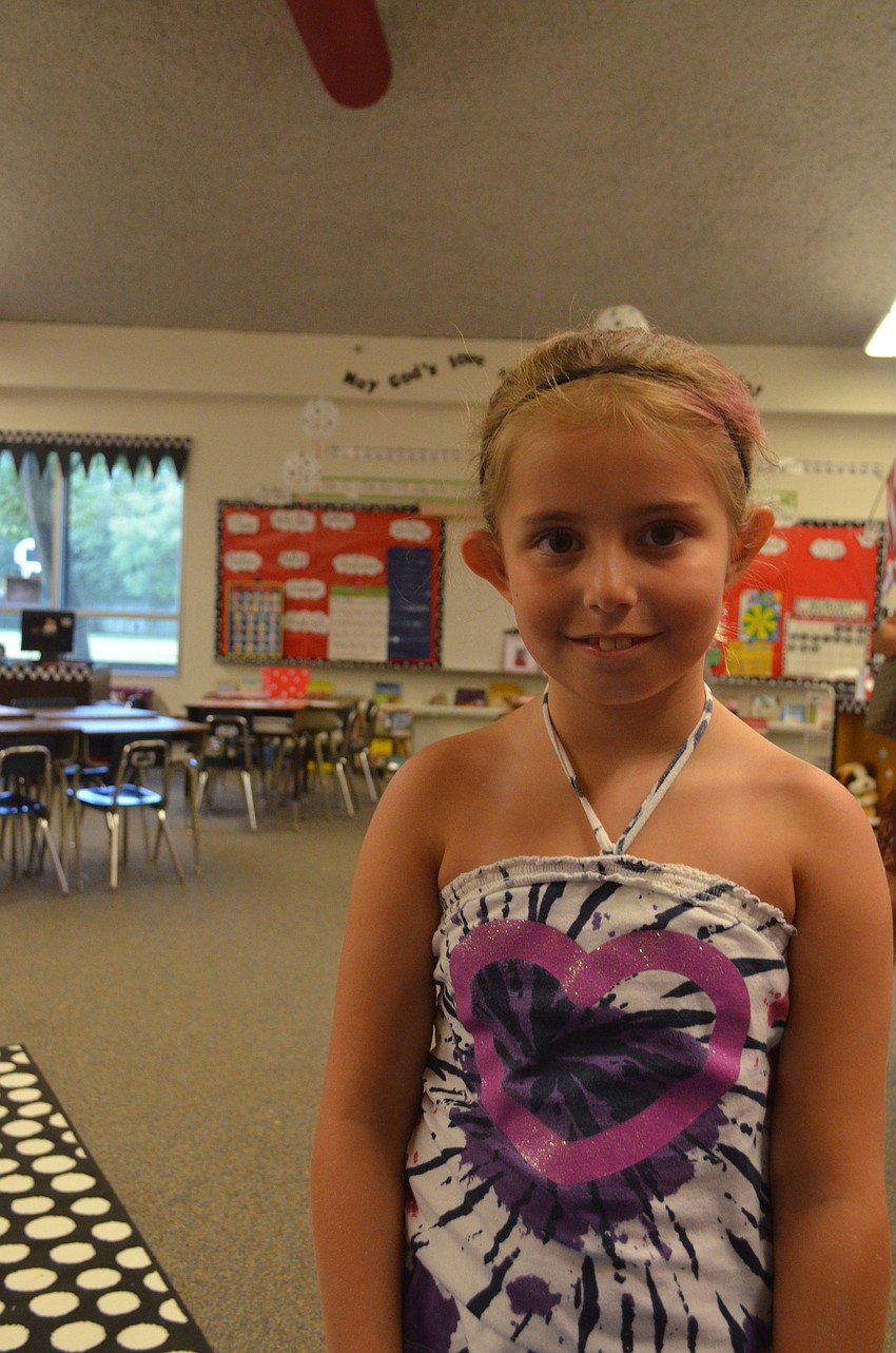 Katherine Lumpkin, 10, her sister Mallory, 8, Avery Blechta, 10, and her sister Grace, 11, bring supplies to St. Martha for the Back to School Bash.