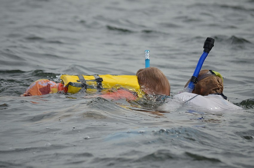 Asher Vandenhoek and Amber Whittle search for scallops.