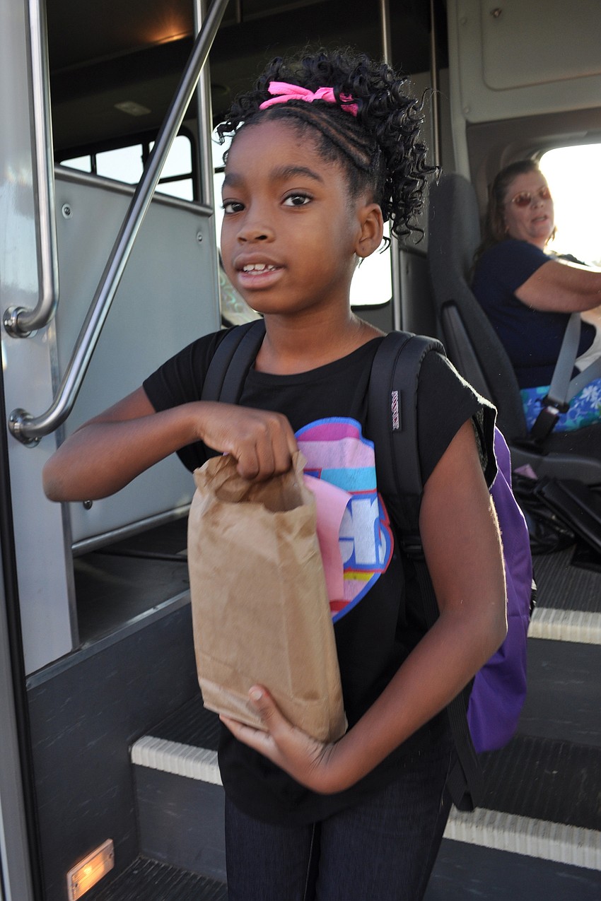 Satoria Denis, 8, greeted Gullett staff after arriving by bus with her sister, Sanaa.