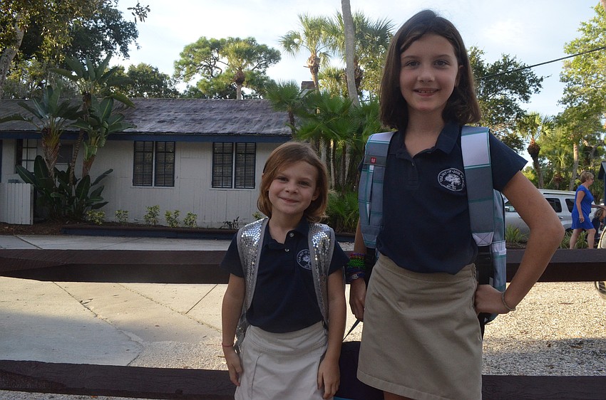 Sisters Kate L., 5, and Alex, 9, head to their first day of school 8 a.m., Wednesday morning.