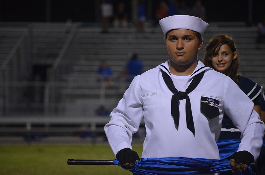 Junior Aaron Segal performs during halftime in the Color Guard.