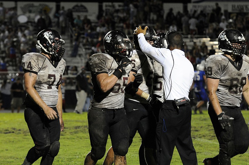 Braden River coach Curt Bradley congratulates the Pirates on their defensive effort.