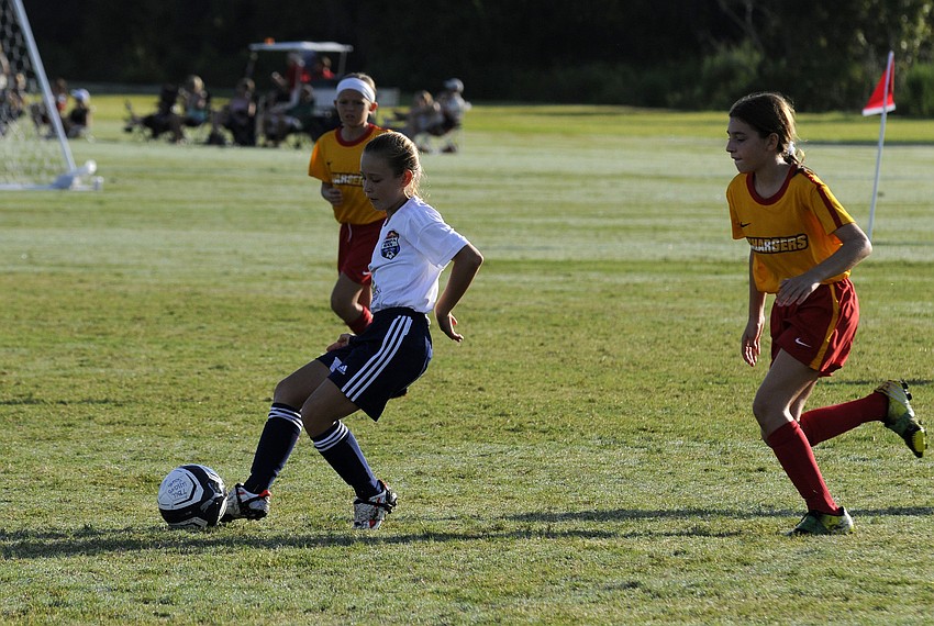 Ten-year-old Casey Buckley looks to pass the ball to an open teammate.