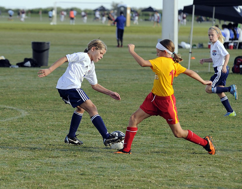 Tampa Bay United South defender Katie Schiano attempts to maneuver the ball past the Clearwater Chargersâ€™ Chloey Conte.