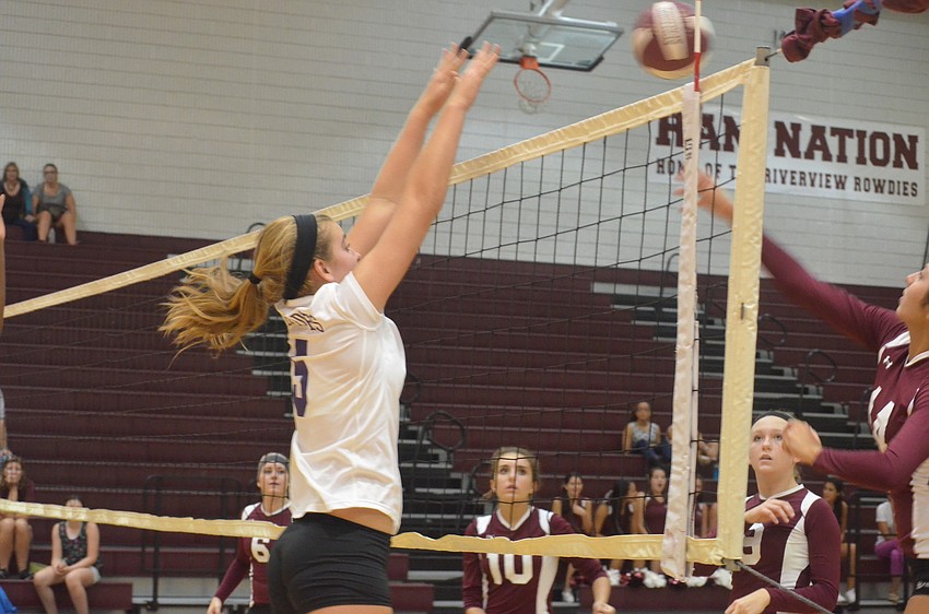 Booker player Ashley Waters hits the ball over the net as Riverview players try to go for it.