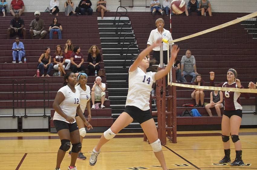Booker player Yamaris Guevarez gets the volleyball over the net.