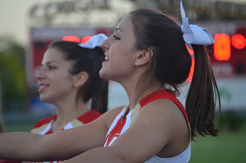 Brooke Devine, 17, energizes the crowd with other cheerleaders.