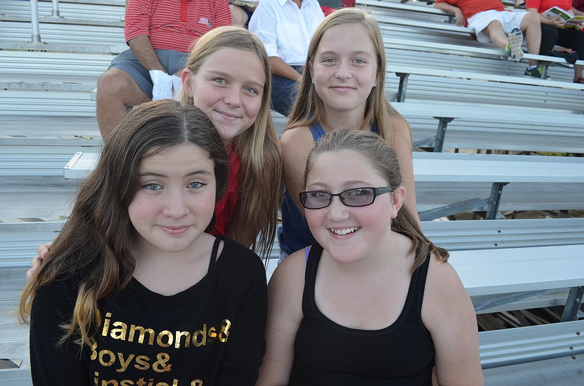 Isabella Atwood, 11, Emily McGregor, 11, and sisters Victoria Snyder, 12 and Amanda, 11, wait for the football game to begin.