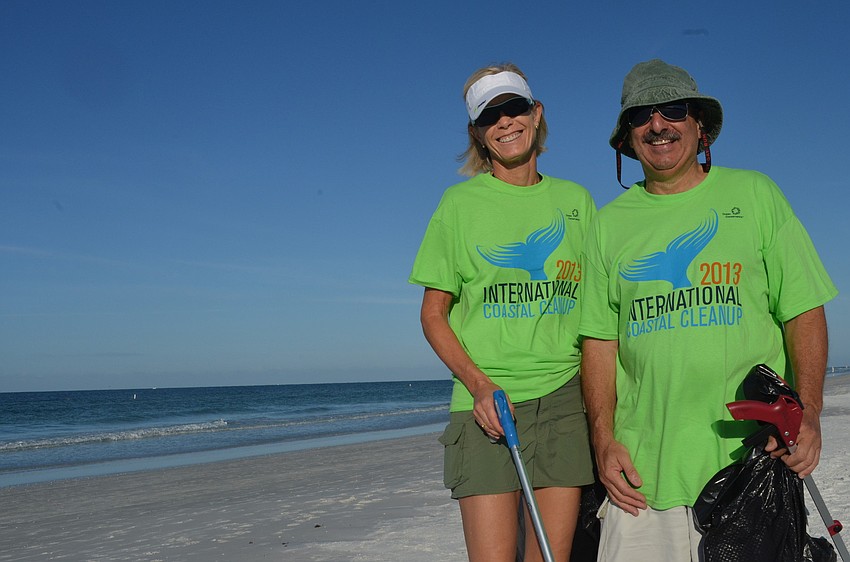 Bea Langsdorf and Michael Shay help pick up trash on Siesta Key Beach.