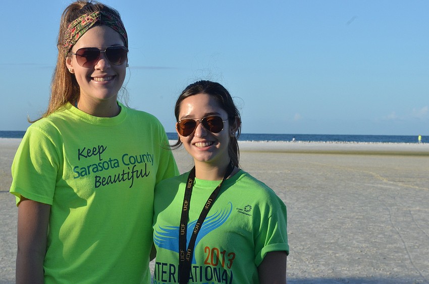 Riverview High School Do Something Club members Silvia Fridezotto, 17, and Valeria Bitrago, 17, get together Saturday morning on Siesta Key Beach to pick up trash.